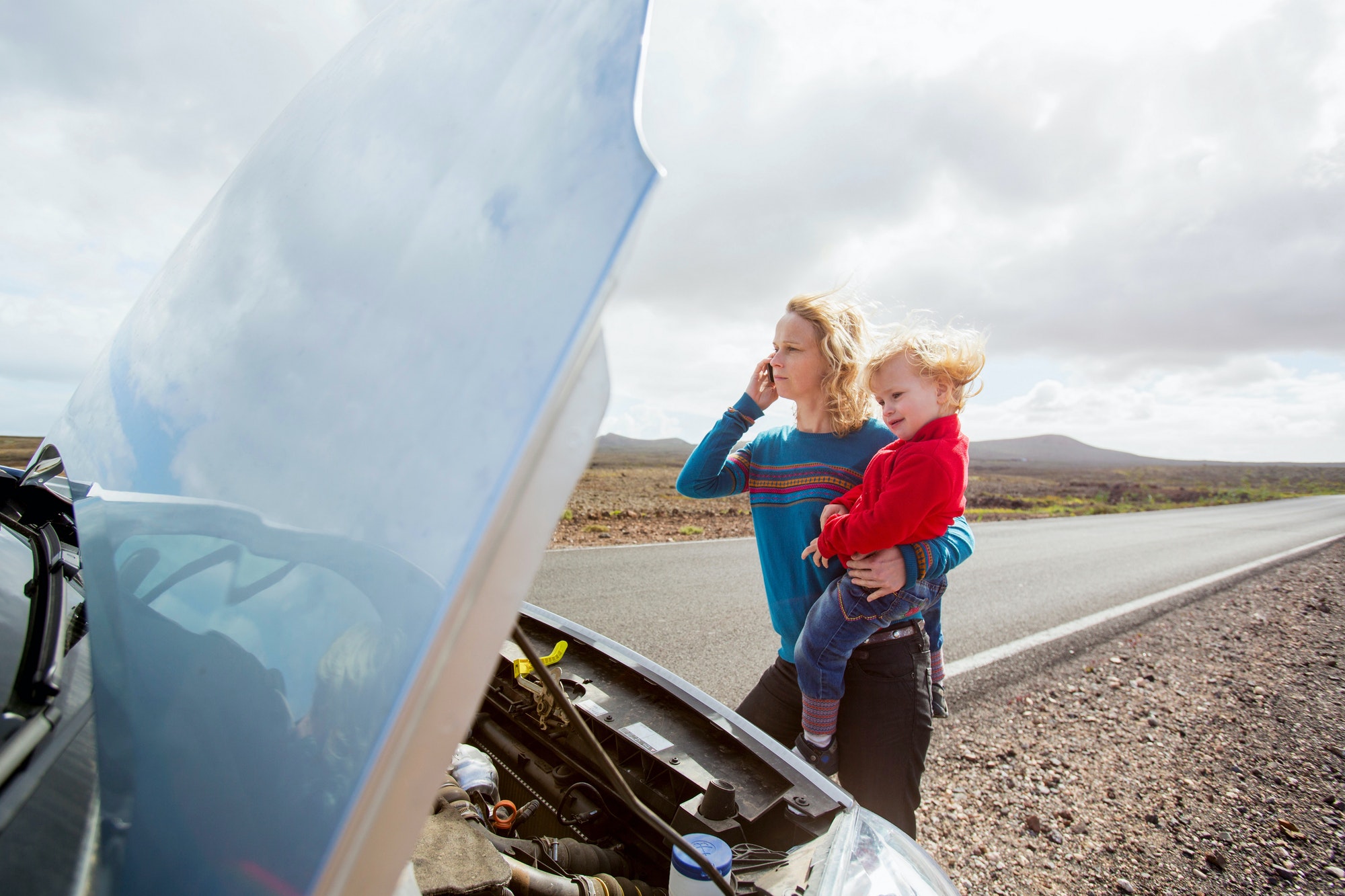 Mother and daughter with broken down car