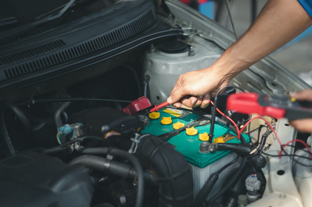 Professional mechanic checking customer's car's electrical system brought in for repair, all types o